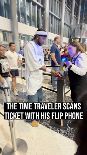 The time traveler scans his ticket with his flip phone. | Time Traveler from 2005