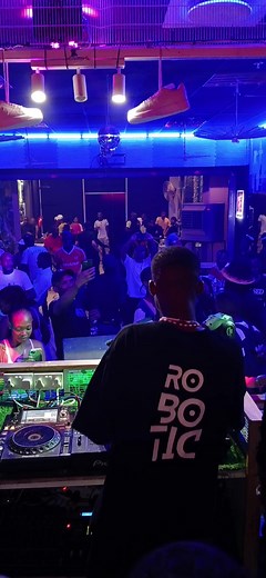 DJ Mixing Music in a Lively Nightclub Setting