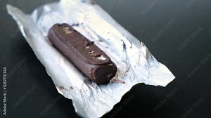 Worms crawls on chocolate candy. Crawling larvae and eggs laid on food. Not fresh spoiled product. A disgusting sight. Sickening and disgusting. Violation of storage conditions in a grocery store. 4K