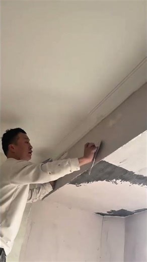 Applying plaster to the wall and smoothing the ceiling surface using a small metal scraper tool now