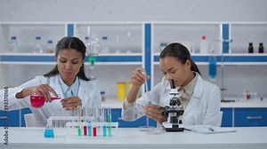 African american scientists in white coats working with samples in laboratory