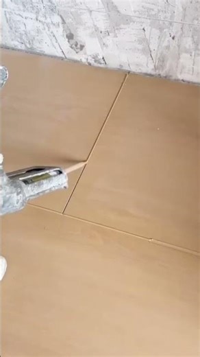 the process of filling gaps in ceramic floor tiles