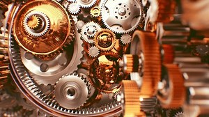Close-up of interlocking gears moving in perfect sync. A macro shot highlights the intricate details of the mechanical system, symbolizing efficiency and precision.