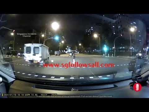 A dog owner trying to retrieve her playful dog in the middle of a cross junction