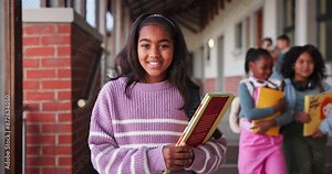 Face, girl and learner with book in school for learning, education and development as student in outdoor. Female child, headphones and smile for growth, skills and scholarship in language or math