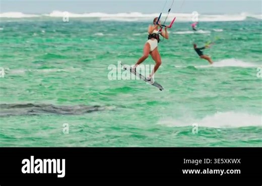 Sports woman kitesurfing in ocean in white bikini. Extreme summer sports Stock Video Footage - Alamy