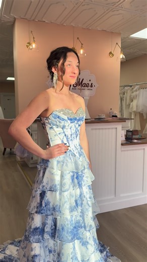 Soft, romantic, and made for a moment ✨ This white blue floral gown is giving main-character energy in the sweetest way — layered ruffles, a dreamy silhouette, and an embellished top that catches the light just right. Perfect for the girl who wants a little soft elegance. Currently in store in a size 4, and available to order in any size. Prom season is calling 🤍 Come try her on at Ruby Mae’s. ✨ www.shoprubymaes.com 🕰️ Open Wednesday–Saturday 12–6 Sunday–Tuesday by appointment #prom2026 #promd