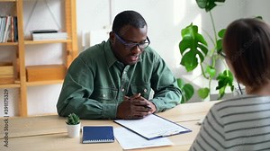 Job interview at office, african boss ask applicant questions Spbas. 30s man talk to woman about career, check resume. Discuss employment. Concept diversity, customer, candidate