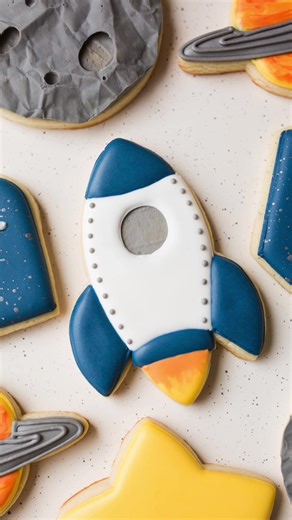 Rocket cookie decorated with royal icing for space birthday set. Cookie Cutter: Mike’s Cookie Cutters #cookiedecorating #royalicing #sugarcookies #relaxing #satisfying