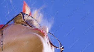 Beautiful young blonde girl sitting and vaping. Woman puffs on a vape pen device. Blowing smoke out of your mouth deliciously. Close-up cinematic smoking.