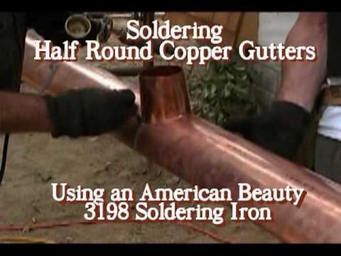 Soldering half round copper gutters.