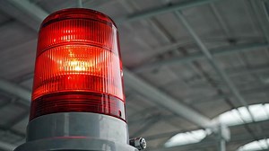 Download Red rotating beacon used for alert in industrial setting for free