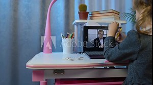 Preschool child girl distance online learning at home. Cute kid pupil watching video lessons studying using digital laptop computer. Children remote study homework education on covid-19 quarantine