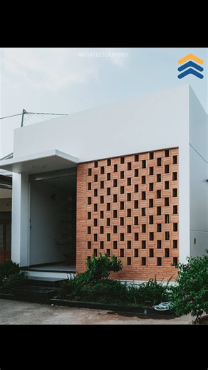 A Small House That Feels Like Heaven | Tropical Home Design in Vietnam | 90odesign This small tropical house near Ho Chi Minh City, Vietnam, proves that you don’t need a big house to live beautifully! Spread across 2,150 sq ft, this home by 90odesign is designed around a central indoor garden — bringing sunlight, ventilation, and calmness to every corner. 🌿 The front façade uses double brick walls to block harsh sunlight while allowing cool air inside. Materials like rough brick, walnut wood, a