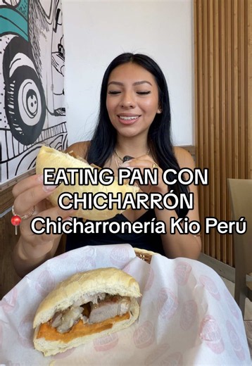 Enjoying Pan Con Chicharrón in San Miguel, Peru
