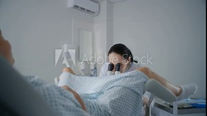 Gynecology room in hospital. Female gynecologist uses colposcope, takes tests from patient. Woman lies on gynecological chair during colposcopy procedure. Preparation for pregnancy. Modern clinic.