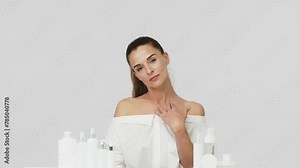 Advertising of spa treatments, anti-aging care products for delicate dry skin. Portrait of an attractive middle-aged woman next to mock-ups of jars of cream and cosmetology natural cosmetics.