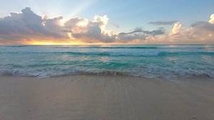 Beach sunrise and crashing waves on the beach