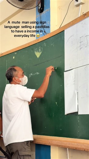 A Mute Man Using Sign Language to Sell Pastillas