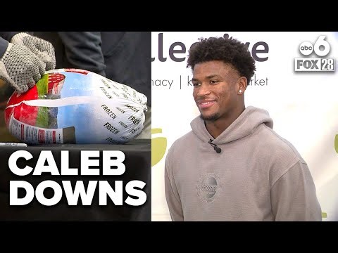 Caleb Downs hands out free turkeys and hams at the Mid-Ohio Market ahead of Thanksgiving