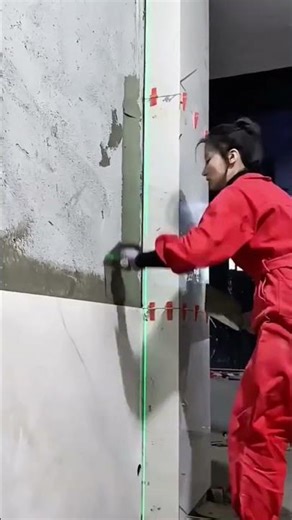 Construction Worker Using a Hammer Drill for Tile Demolition