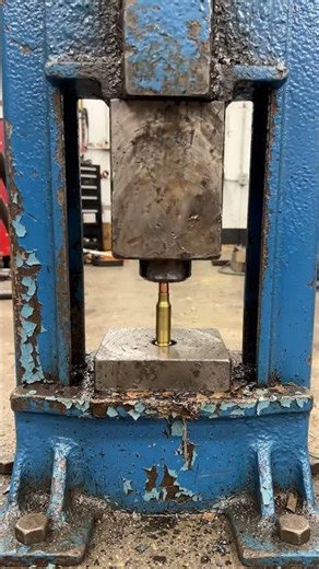 The blue hydraulic press is old and rusty with chipped paint