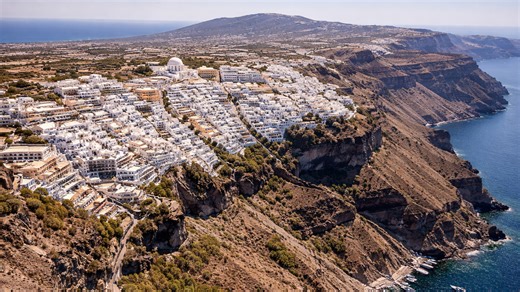 Cascading white homes over the cliffs of Santorini