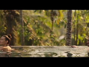 Couple Together Relaxation and Spending Time in Infinity Swimming Pool Outdoors During Tropical