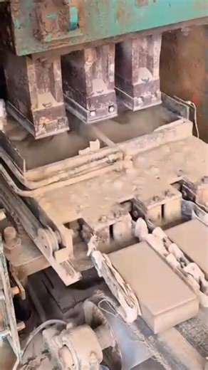 making many uniform rectangular bricks with a large industrial pressing machine