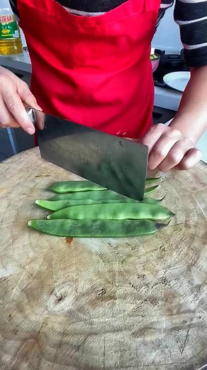 Chopping fresh snap peas for a delicious meal! 🥗🔪 Fresh ingredients make the best dishes. #HealthyEating #KitchenLife | Olga Webb
