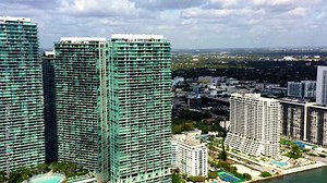 4k Aerial of high-rise buildings at the bay's frontline. Modern skyscrapers in the residental area city. Amazing city veiw Miami, Florida, USA. Apartment buildings with beautiful ocean view