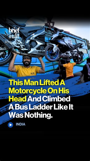 This man lifted a motorcycle on his head and climbed a bus ladder like it was nothing