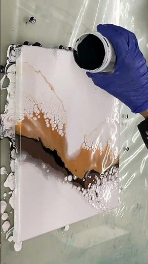 Abstract acrylic pouring painting featuring stunning cells and intricate lacing.