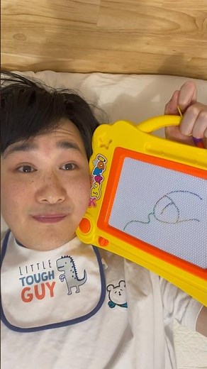 Baby draws on the magna doodle for the first time