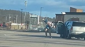 Shocking moment former football star slams petite woman to ground in fit of road rage