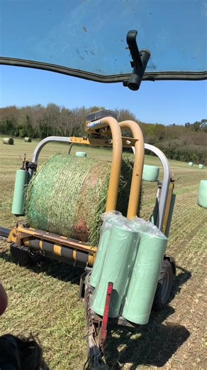 Large Baler Machine in Action on Rural Farm