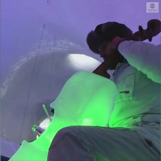 Musicians play instruments made of ice in igloo on Italian glacier