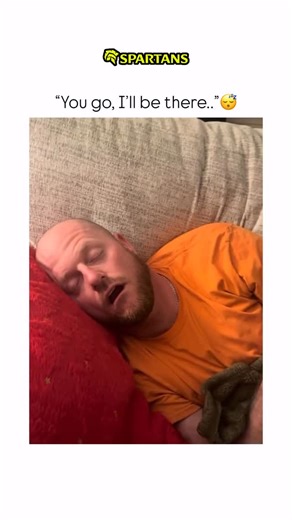 Sarcasm wrrld | In this short video, a man is captured in a deep, snoring sleep on a couch. He is lying on his side, his head resting against a bright red... | Instagram