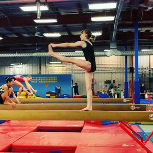 Challenge of the weekend! Try it on the floor for the beginning and have FUN! Thank You @exersusie for this exercise ❤️. I liked it and moved it up on the balance beam! #gymnastics #core #coreworkout #balance #squats #girlpower #challenge #fitgirl #gymgirl #strongnotskinny #teamolympia #fun #workinghard #strength #knee #gym #gymtime #stittsville #kanata @olympia.gymnastics.ottawa | Olympia Gymnastics