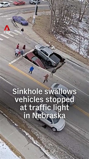 A sinkhole opened without warning at a Nebraska intersection on Tuesday (Feb 24), partially swallowing two vehicles. No injuries were reported. The Omaha Police Department has closed the street in both directions, warning that the sinkhole could expand. #us #usnews