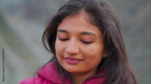 Portrait of beautiful Indian female looking downwards. Brown Indian skin tone. Indian ethnicity people. Calm woman with freckled skin, Black hair. Confident woman thinking over her life.