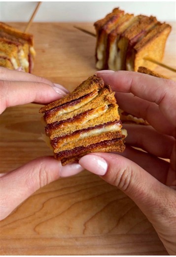 It's #trendingtuesday and @Alexa Santos is making Layered Sandwich Skewers inspired by @ashleymarkleeats 🥪 Get the recipe below. INGREDIENTS: Slices of bread Slices of cheese Slices of salami 1 egg, beaten RECIPE: 1.On a clean cutting board, lay down one slice of bread. Top it with a slice of cheese and then some salami. Stack another piece of bread on top and repeat until you’ve created 5-8 layers. 2.Use a rolling pin or heavy pan to squish the sandwich down flatter. Cut off the crust. Cut the