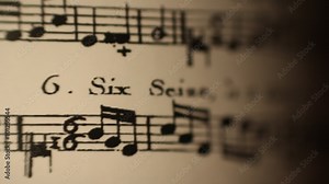 Sheet music rolling dynamic light shallow depth of field