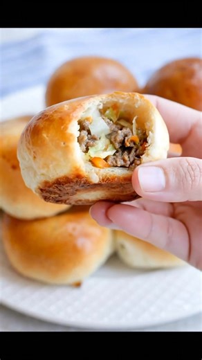 This Runza recipe uses pre-made frozen bread dough along with browned ground beef that is mixed with onion and green cabbage, seasoned with salt and freshly ground black pepper. | Recipes & Cooking Guide