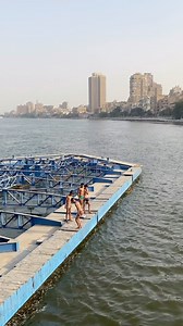 Teenage boys making a splash off Imbaba Bridge, capturing the essence of carefree moments by the water. 🎥: @houbbaa | MyEgypt