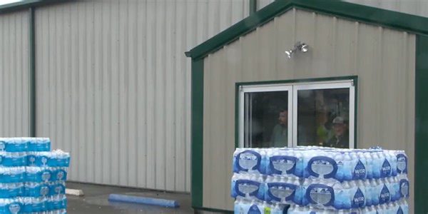 Residents without running water for 2 weeks are catching rain in buckets to bathe