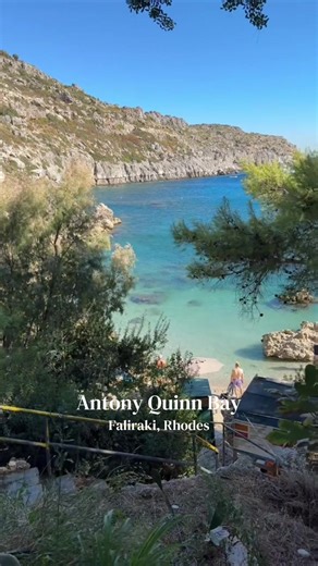 Antony Quinn Bay in Rhodes, Greece. Famous for its crystal clear water, rocky scenery and incredible snorkeling spots. One of the most beautiful bays on the island and a must-visit beach for travelers planning a summer trip to Rhodes. #rhodes #rodos #faliraki