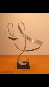 61K views · 1K reactions | Kinetic Balance Sculpture: two ribbons of aluminum balance on a third in equilibrium with gravity- but free to rotate about pivot points above each system’s center of mass. A vintage find from 1974 by artist John W. Anderson. ➡️ Follow the link in my profile to find balance sculptures and other amazing items featured here on @physicsfun #equilibrium #centerofmass #physics #physicstoy #balance #balancetoy #science #scienceisawesome | Physicsfun | Facebook