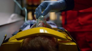 Paramedic hand in glove holding oxygen mask on patient face in emergency car Free Stock Video Footage