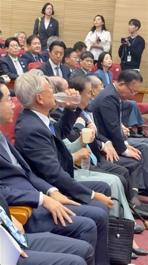 Former President Moon Jae-in drinking bottled water after his congratulatory remarks, September 1...